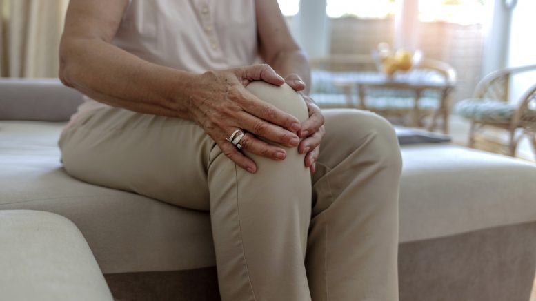 older lady holding knee